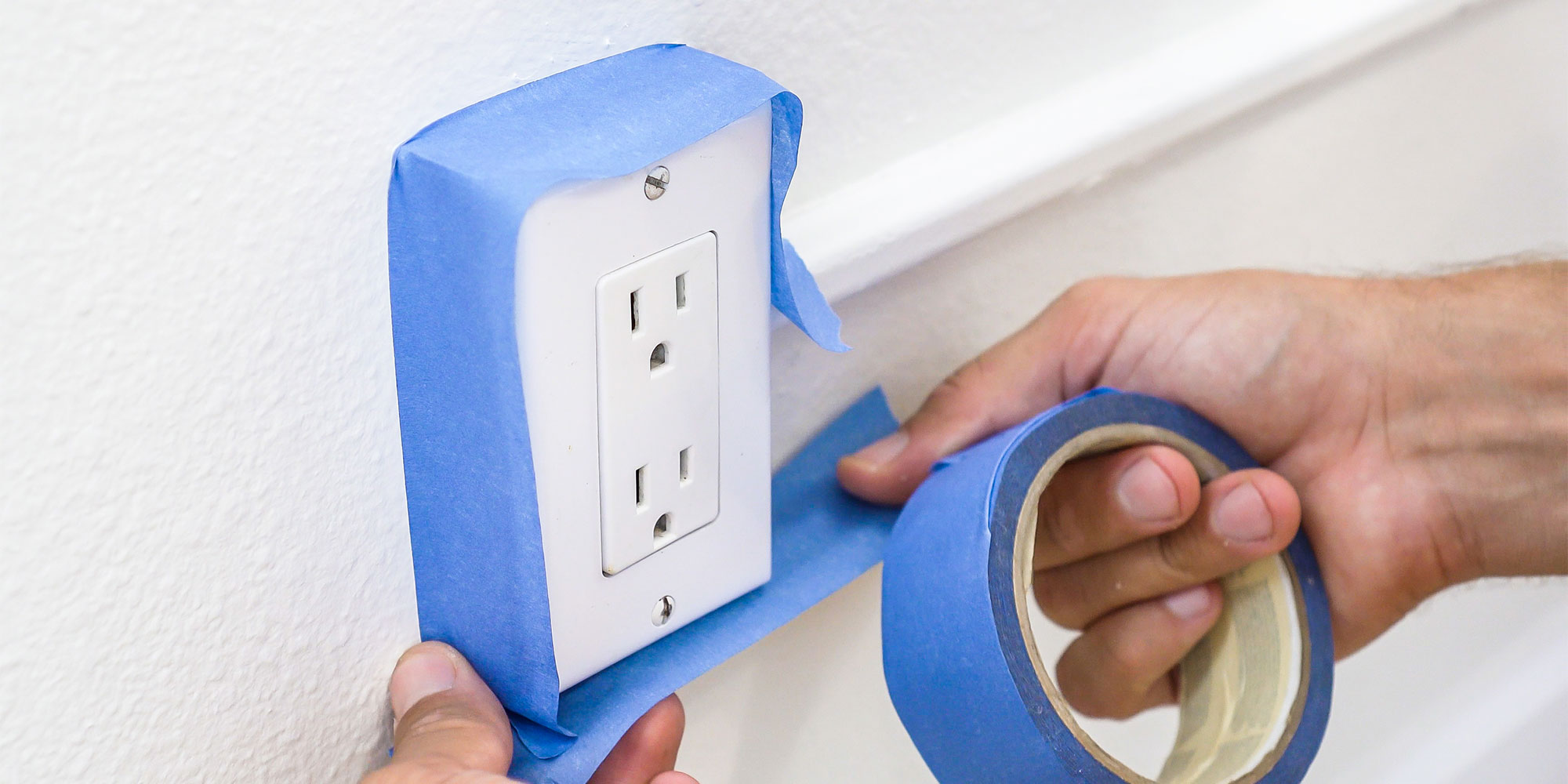 Putting tape around plug socket