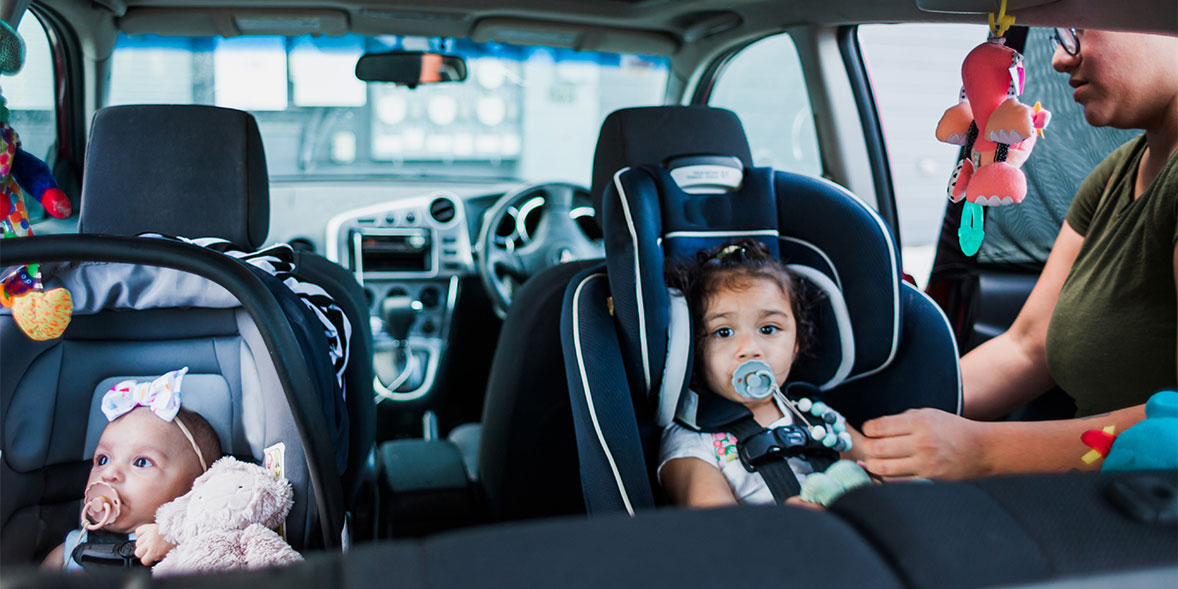 Two children in rear-facing car seats
