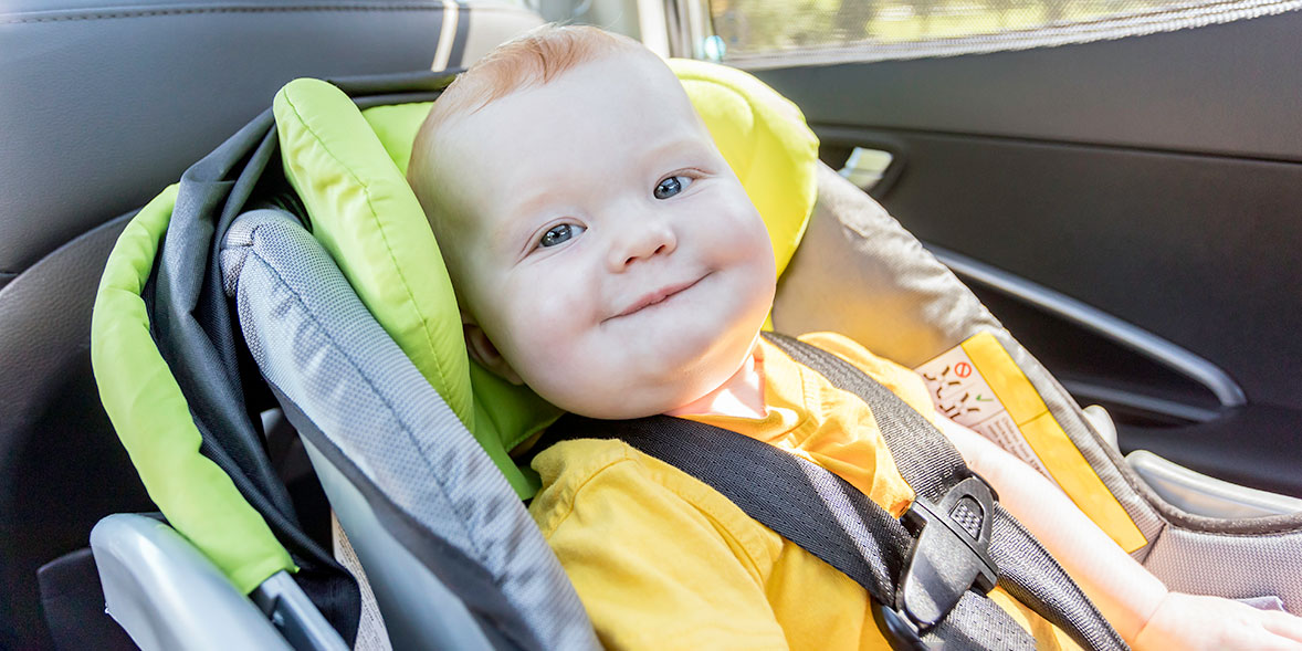 Baby in a car seat with a chest clip on the harness