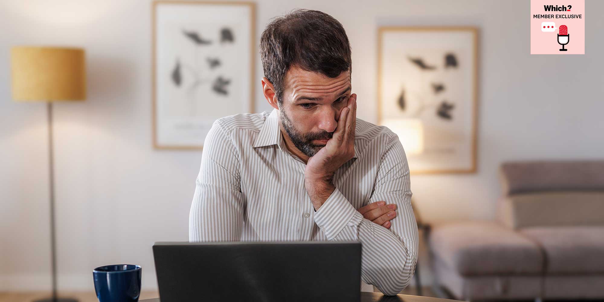 A man looking frustrated at his laptop