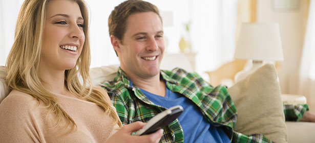 Happy couple watching TV